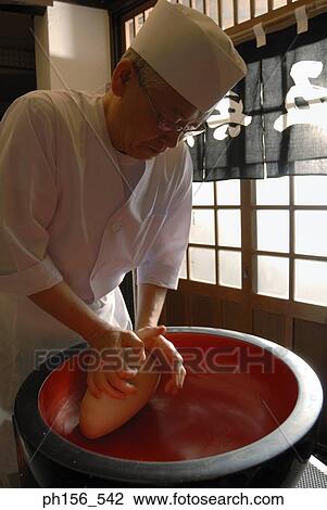 Stock Image - Close-up of a chef kneading dough. Fotosearch