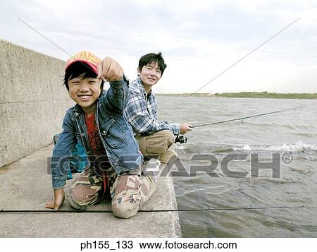 Close-up of a child smiling and showing a fish View Large Photo Image Stock Image - Close-up of a child smiling and showing a fish. Fotosearch