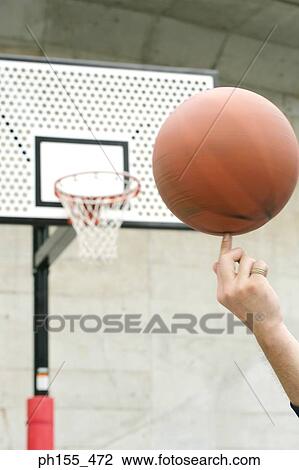 Close-up of a human hand spinning a basketball View Large Photo Image Stock Image - Close-up of a human hand spinning a basketball. Fotosearch