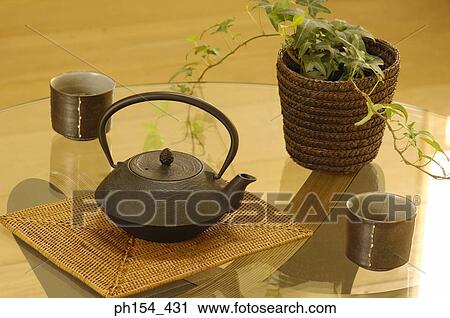 Stock Image - Close-up of a kettle with two cups on the table. Fotosearch