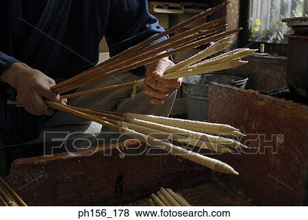Close-up of a man making candles in a factory View Large Photo Image Stock Photo - Close-up of a man making candles in a factory. Fotosearch