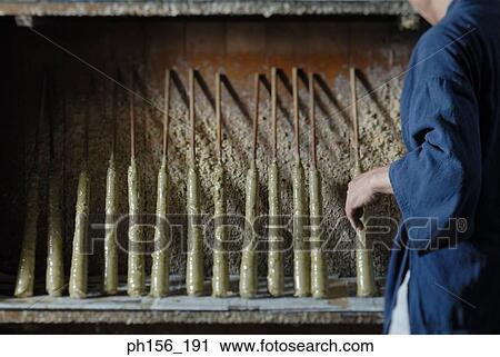 Close-up of a man putting candle sticks in a row View Large Photo Image Stock Image - Close-up of a man putting candle sticks in a row. Fotosearch