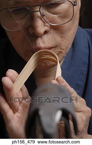 Close-up of a mid adult man bending a bamboo strip View Large Photo Image Stock Photo - Close-up of a mid adult man bending a bamboo strip. Fotosearch