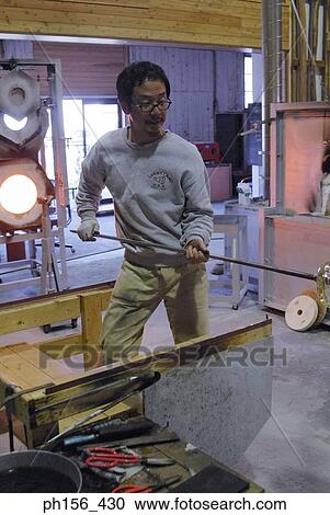 Close-up of a mid adult man holding an iron rod View Large Photo Image Stock Image - Close-up of a mid adult man holding an iron rod. Fotosearch