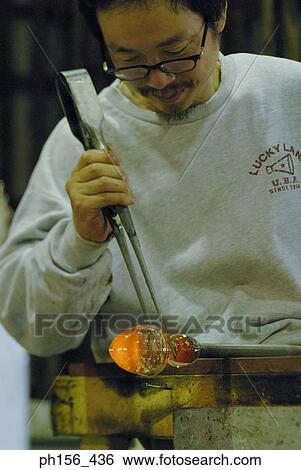 Close-up of a mid adult man molding a glass bulb View Large Photo Image Stock Photograph - Close-up of a mid adult man molding a glass bulb. Fotosearch