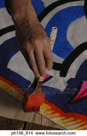 Picture - Close-up of a painter's hands painting. Fotosearch