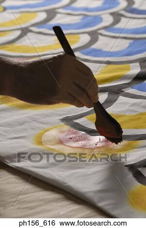 Close-up of a painter's hands painting on a sheet View Large Photo Image Stock Photograph - Close-up of a painter's hands painting on a sheet. Fotosearch