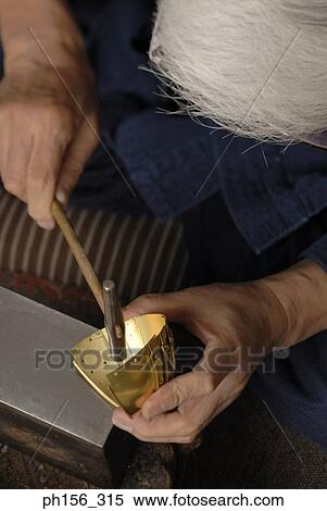 Close-up of a person making a metal bowl with a hammer View Large Photo Image Stock Photography - Close-up of a person making a metal bowl with a hammer. Fotosearch