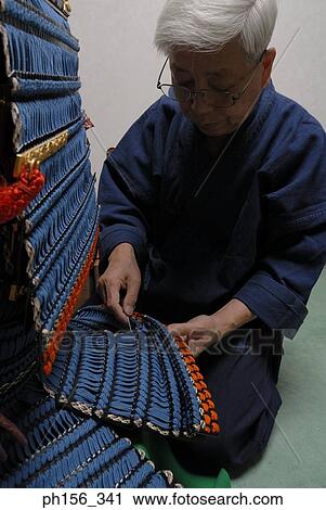 Close-up of a person making a traditional costume with a work tool View Large Photo Image Stock Image - Close-up of a person making a traditional costume with a work tool. Fotosearch