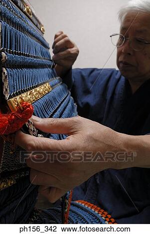 Close-up of a person making a traditional costume with a work tool View Large Photo Image Stock Image - Close-up of a person making a traditional costume with a work tool. Fotosearch