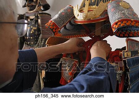 Stock Photography - Close-up of a person making a suit of armor. Fotosearch