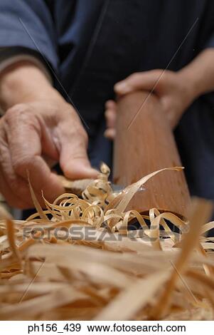 Close-up of a person shaving wood View Large Photo Image Stock Photo - Close-up of a person shaving wood. Fotosearch