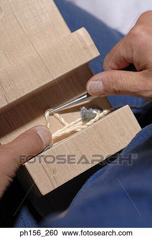 Stock Image - Close-up of a person using a needle. Fotosearch