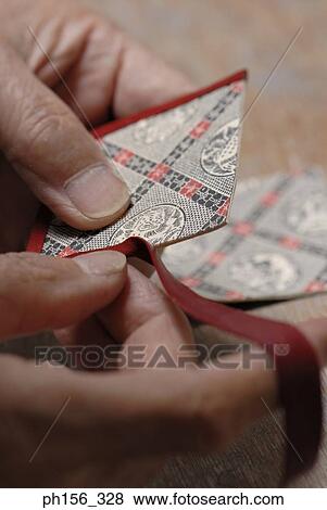 Close-up of a person's fingers pasting ribbon around cardboard View Large Photo Image Stock Photo - Close-up of a person's fingers pasting ribbon around cardboard. Fotosearch