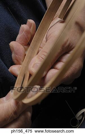 Close-up of a person's hand attaching wooden circles View Large Photo Image Stock Photography - Close-up of a person's hand attaching wooden circles. Fotosearch