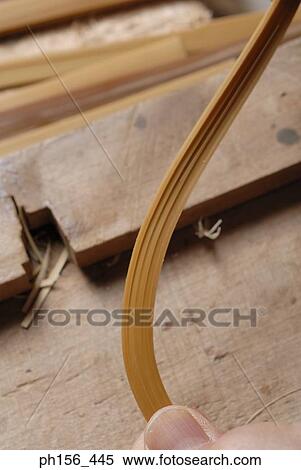 Close-up of a person's hand bending a strip of wood View Large Photo Image Stock Photography - Close-up of a person's hand bending a strip of wood. Fotosearch