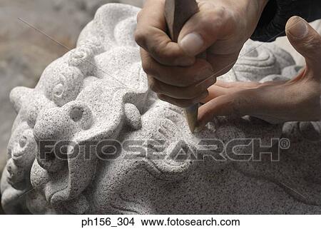 Close-up of a person's hand carving a statue with a chisel View Large Photo Image Picture - Close-up of a person's hand carving a statue with a chisel. Fotosearch