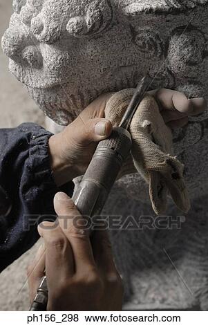 Close-up of a person's hand carving a statue with a drill View Large Photo Image Stock Photo - Close-up of a person's hand carving a statue with a drill. Fotosearch