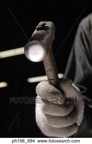 Close-up of a person's hand holding a hammer View Large Photo Image Picture - Close-up of a person's hand holding a hammer. Fotosearch
