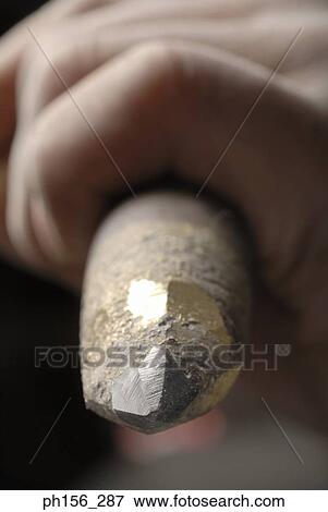 Close-up of a person's hand holding a chisel View Large Photo Image Stock Photo - Close-up of a person's hand holding a chisel. Fotosearch