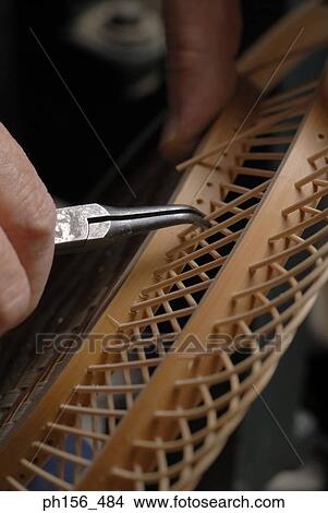Close-up of a person's hand making a wooden craft product View Large Photo Image Picture - Close-up of a person's hand making a wooden craft product. Fotosearch