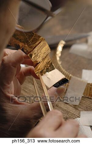 Close-up of a person's hand making a strap with tweezers View Large Photo Image Stock Image - Close-up of a person's hand making a strap with tweezers. Fotosearch