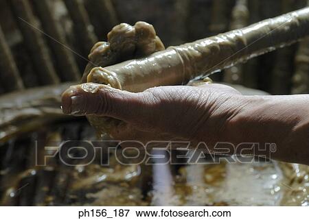 Close-up of a person's hand making a candle View Large Photo Image Stock Photo - Close-up of a person's hand making a candle. Fotosearch