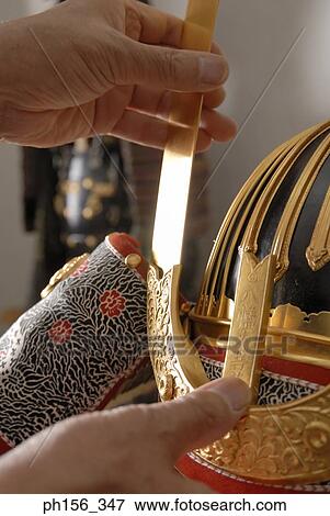 Close-up of a person's hand making a suit of armor View Large Photo Image Stock Photo - Close-up of a person's hand making a suit of armor. Fotosearch