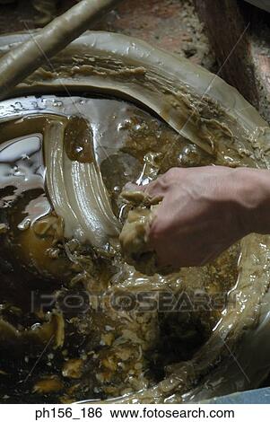 Close-up of a person's hand making a candle View Large Photo Image Stock Photograph - Close-up of a person's hand making a candle. Fotosearch