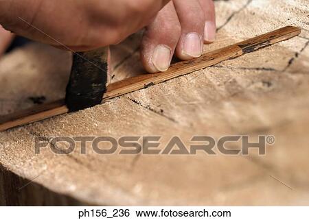 Close-up of a person's hand measuring with a hand tool View Large Photo Image Stock Photograph - Close-up of a person's hand measuring with a hand tool. Fotosearch