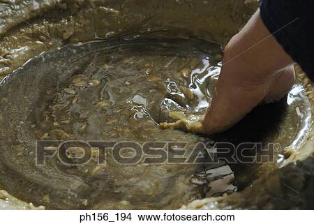 Close-up of a person's hand mixing wax in a bowl View Large Photo Image Picture - Close-up of a person's hand mixing wax in a bowl. Fotosearch