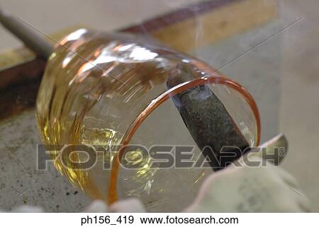 Close-up of a person's hand molding a glass bulb View Large Photo Image Stock Photo - Close-up of a person's hand molding a glass bulb. Fotosearch
