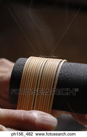 Close-up of a person's hand molding wooden sticks View Large Photo Image Stock Image - Close-up of a person's hand molding wooden sticks. Fotosearch