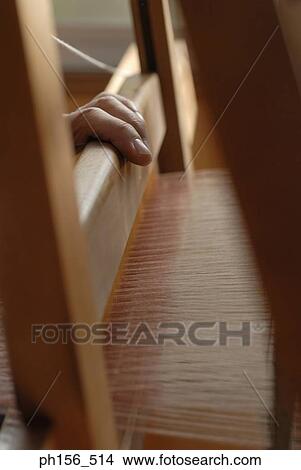 Close-up of a person's hand operating a loom View Large Photo Image Picture - Close-up of a person's hand operating a loom. Fotosearch