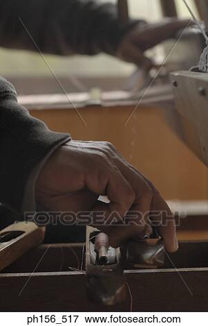 Close-up of a person's hand operating a loom View Large Photo Image Stock Photo - Close-up of a person's hand operating a loom. Fotosearch