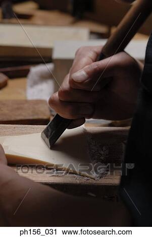 Close-up of a person's hand planing wood with a chisel View Large Photo Image Stock Image - Close-up of a person's hand planing wood with a chisel. Fotosearch