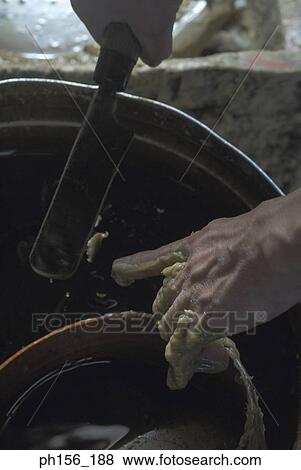Stock Photo - Close-up of a person's hand scraping wax from his hand with a knife. Fotosearch