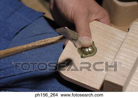 Close-up of a person's hand using a hammer View Large Photo Image Picture - Close-up of a person's hand using a hammer. Fotosearch