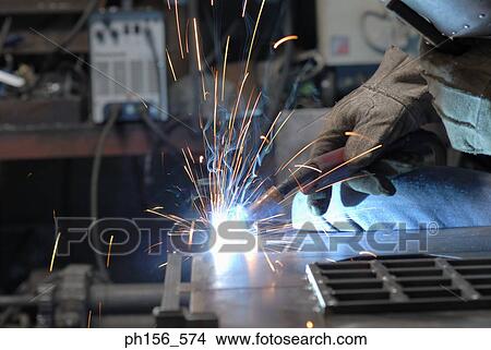 Close-up of a person's hand welding in a workshop View Large Photo Image Picture - Close-up of a person's hand welding in a workshop. Fotosearch