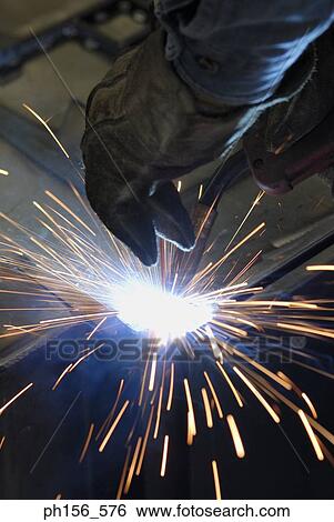 Close-up of a person's hand welding in a workshop View Large Photo Image Stock Photograph - Close-up of a person's hand welding in a workshop. Fotosearch