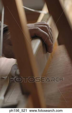 Close-up of a person's hand working on a loom View Large Photo Image Stock Image - Close-up of a person's hand working on a loom. Fotosearch
