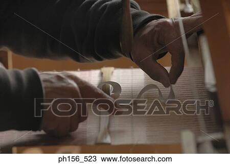 Close-up of a person's hand working on a loom View Large Photo Image Stock Image - Close-up of a person's hand working on a loom. Fotosearch
