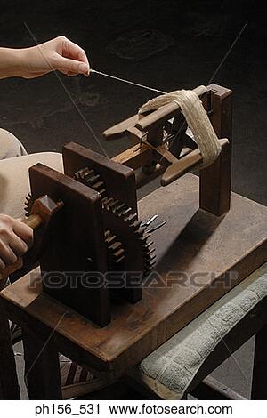 Close-up of a person's hand working on a spinning wheel View Large Photo Image Stock Image - Close-up of a person's hand working on a spinning wheel. Fotosearch