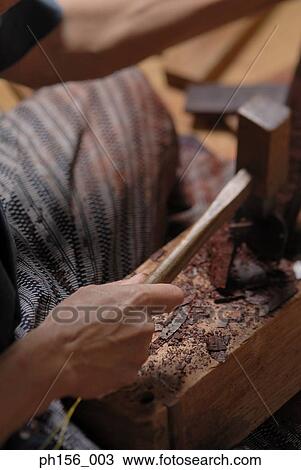 Stock Image - Close-up of a person's hand working with a hammer. Fotosearch