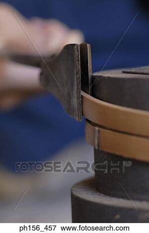 Stock Photo - Close-up of a person's hands bending wooden strips with the help of a pair of pliers. Fotosearch
