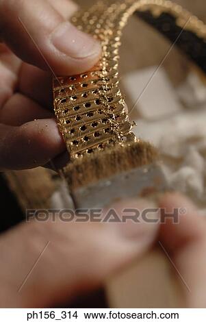 Close-up of a person's hands cleaning a strap with a brush View Large Photo Image Picture - Close-up of a person's hands cleaning a strap with a brush. Fotosearch