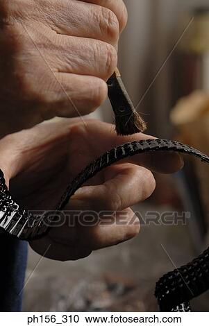 Close-up of a person's hands cleaning a chain with a brush View Large Photo Image Stock Image - Close-up of a person's hands cleaning a chain with a brush. Fotosearch