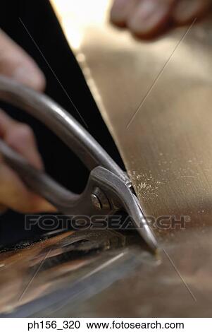 Close-up of a person's hands cutting a sheet of metal with shears View Large Photo Image Stock Image - Close-up of a person's hands cutting a sheet of metal with shears. Fotosearch