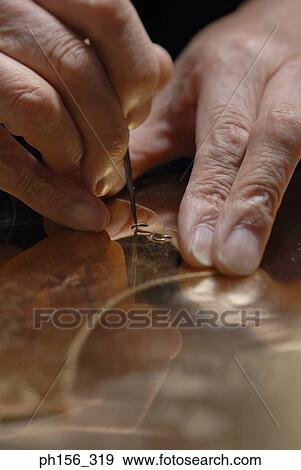 Close-up of a person's hands cutting a sheet of metal with a tool View Large Photo Image Stock Photo - Close-up of a person's hands cutting a sheet of metal with a tool. Fotosearch