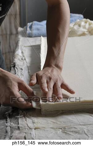 Close-up of a person's hands cutting a sheet of paper with the help of a comb View Large Photo Image Stock Photography - Close-up of a person's hands cutting a sheet of paper with the help of a comb. Fotosearch